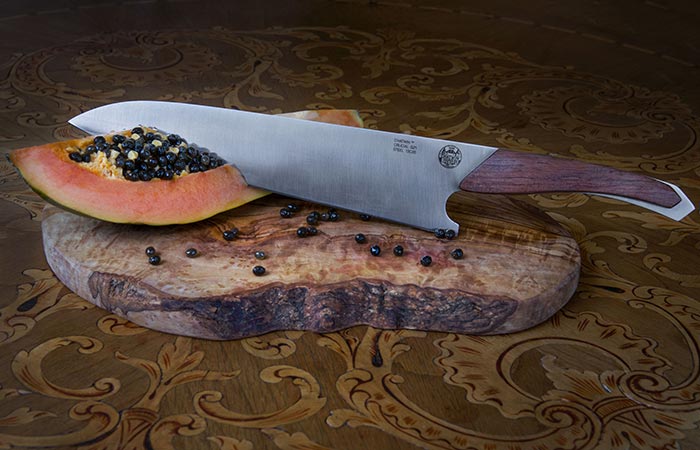 Chatwin Crucial Chef's Knife cutting into a pawpaw.