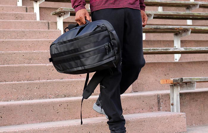 a guy carrying Aer Duffel Pack