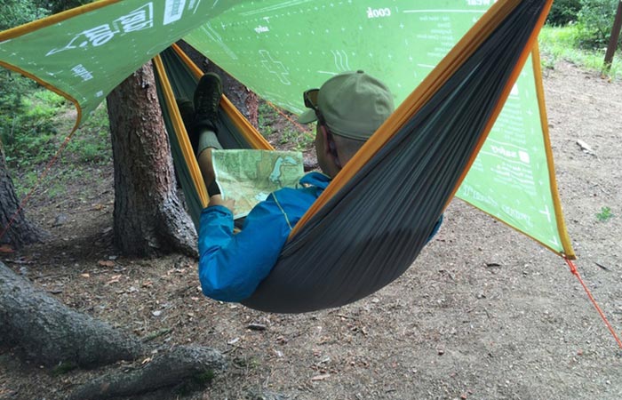 Man using The Original Trip Tarp as a hammock cover