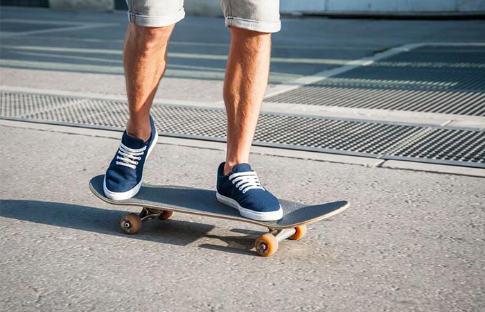 on a skateboard in blue Baabuk sneakers