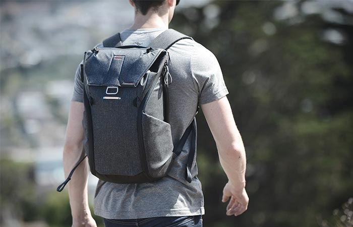 a guy wearing a grey backpack