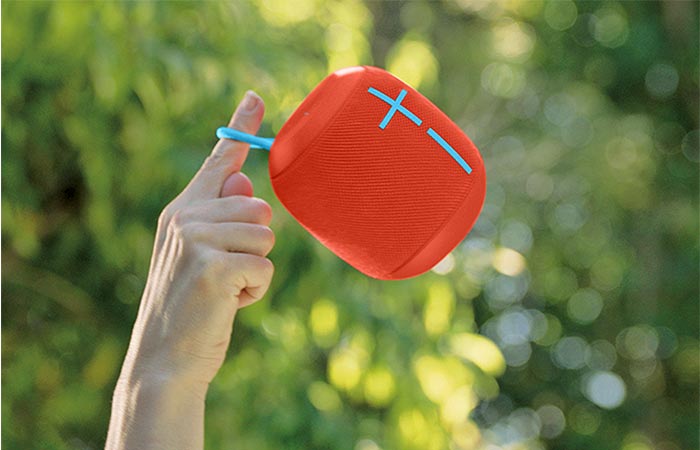 holding red Wonderboom speaker in air