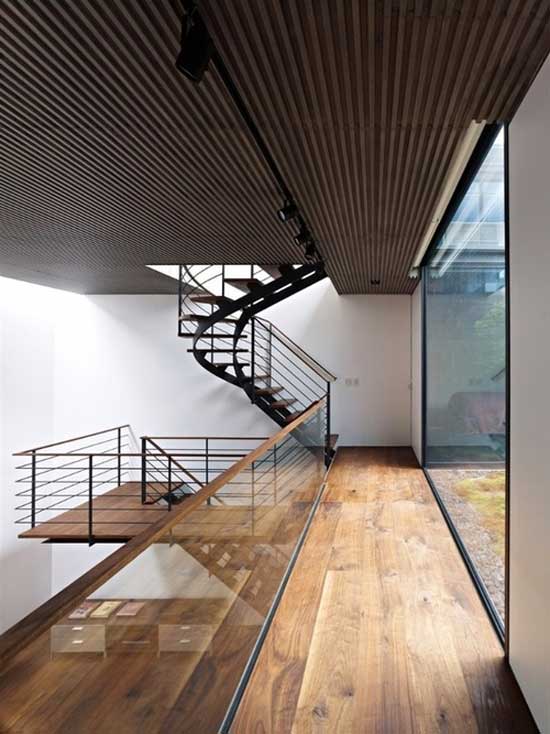 interior design of a floor in brown wood and white colored walls