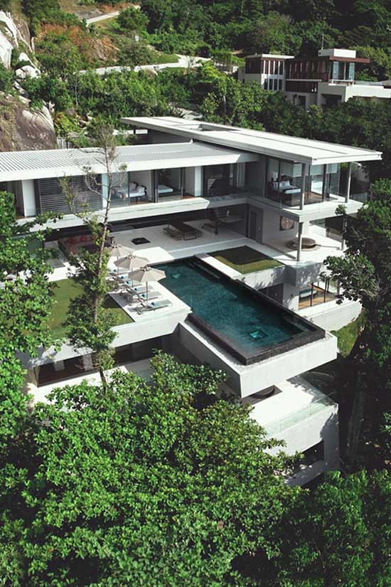 minimal design of a pool and house on a cliff