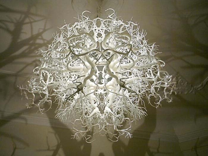 Light sculpture projecting tree shadows on the walls of a room
