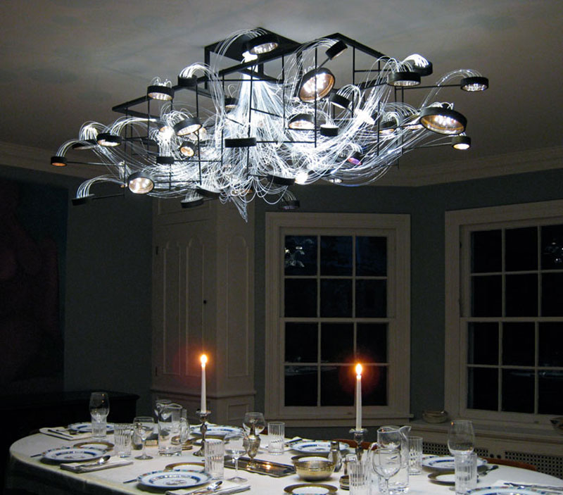Bacterioptica Chandelier designed by Mad Lab attached to the ceiling in a dining room
