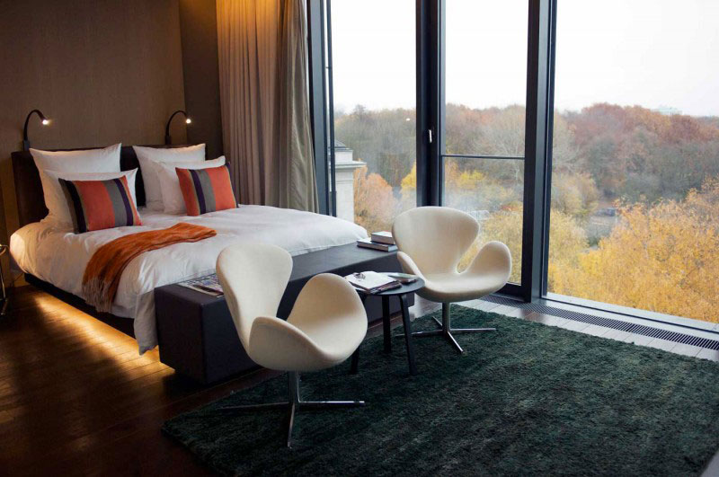 Bed, chairs and window in hotel room in the Das Stue Hotel