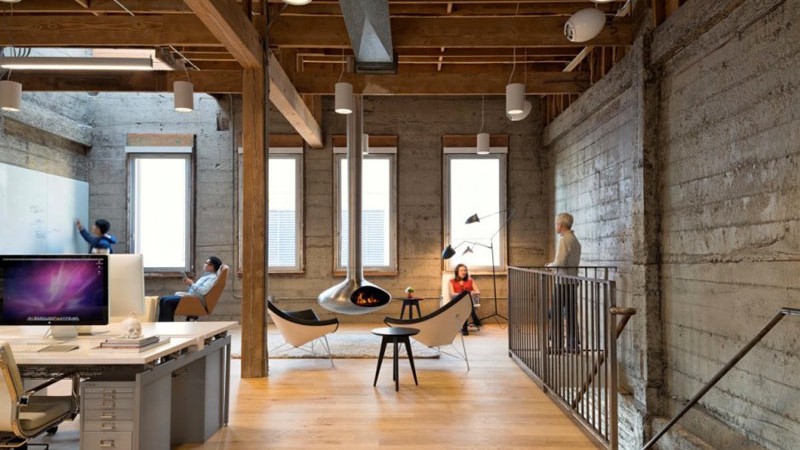 Fireplace, chimney and seats and desks at the Giant Pixel headquarters in San Francisco designed by Studio O+A