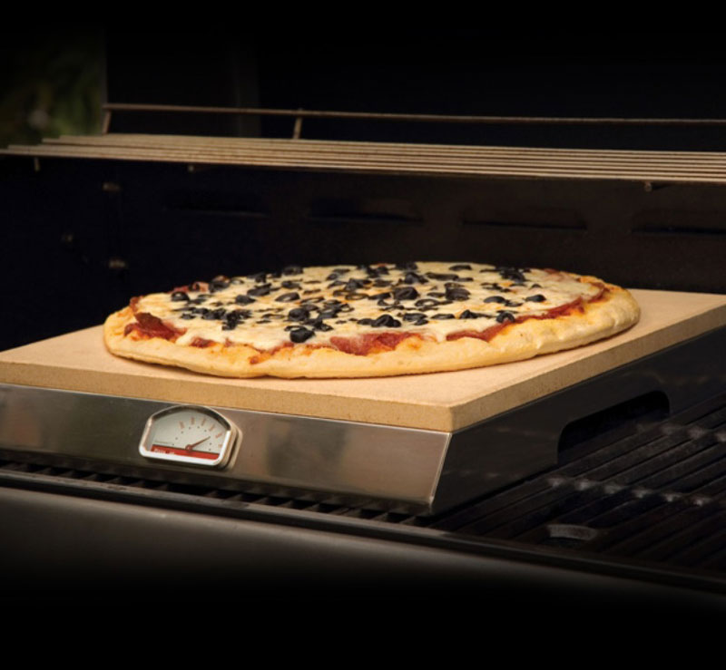PizzaQue Grill Stone on the grill with a pizza baking 