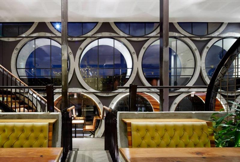 dining booth and view of the exterior through pipe windows at Prahran Hotel in Victoria