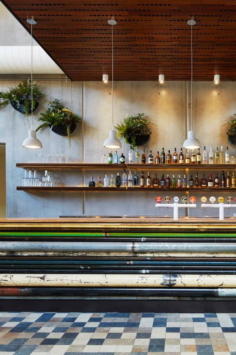bar with bottles and plants at the Prahran Hotel in Victoria