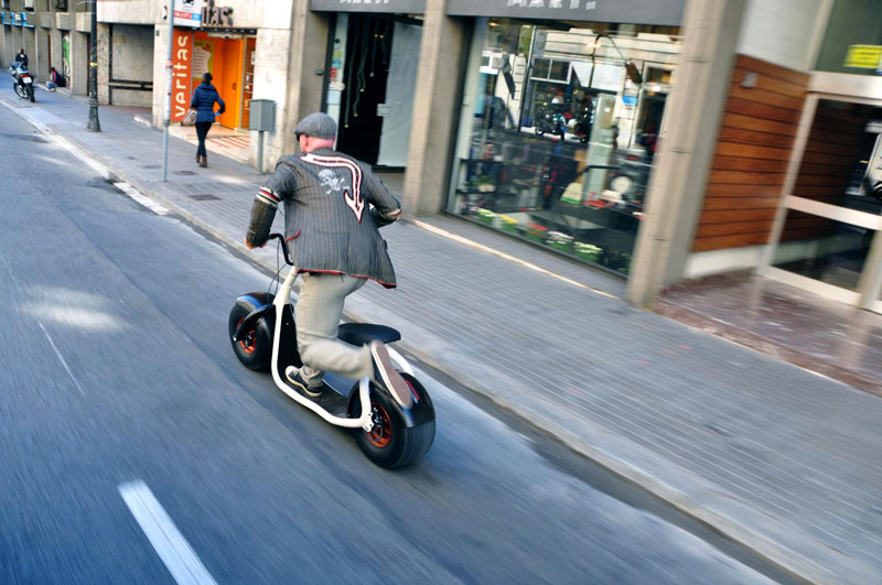 Man cruising on the street on a white Scrooser