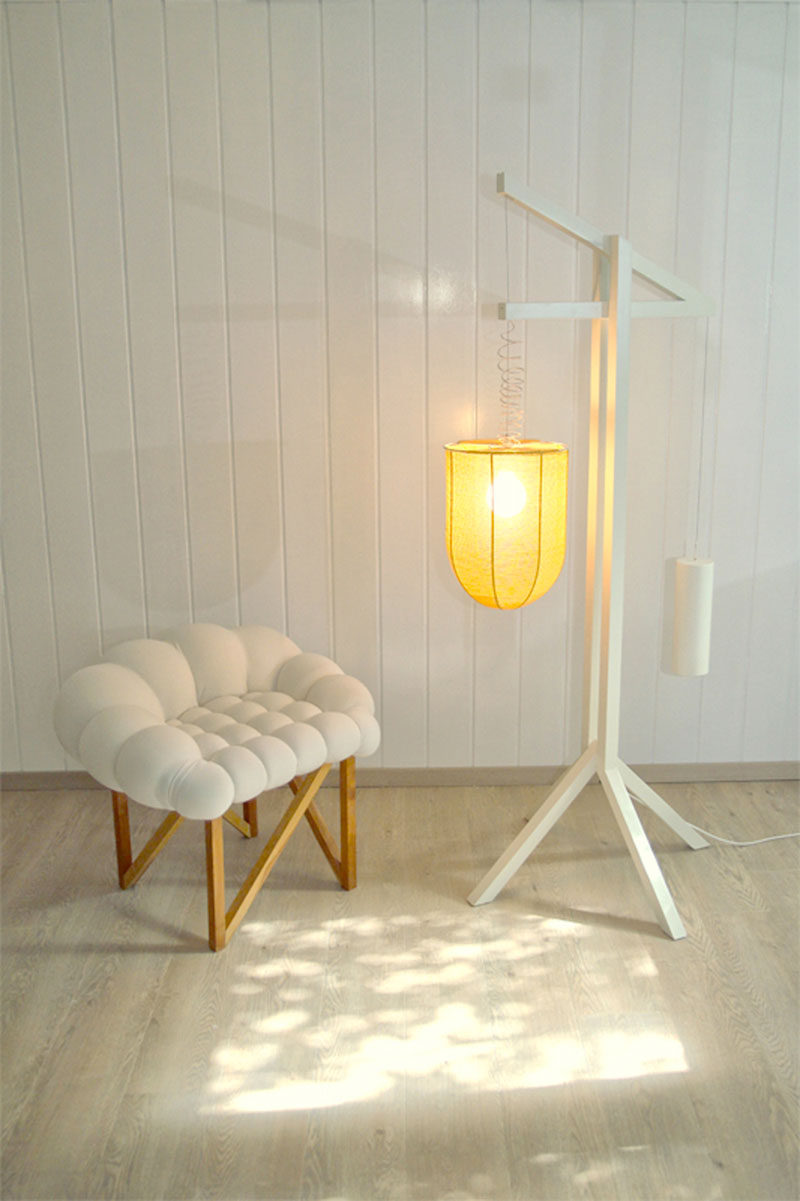 Snobar chair and lamp in a room with white walls
