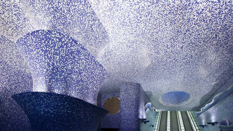 3 sets of escalators and illuminated walls and ceiling at the Toledo Metro Station designed by Oscar Tusquets Blanca