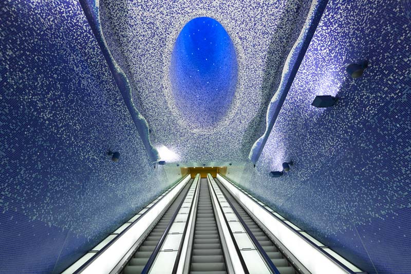 3 sets of escalators and illuminated ceiling at the Toledo Metro Station designed by Oscar Tusquets Blanca