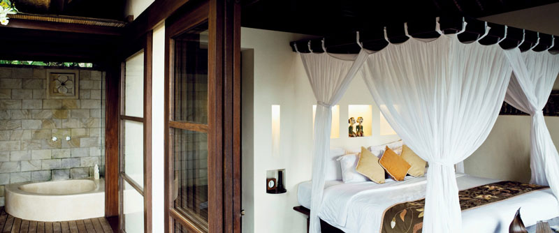 bed and windowns in bedroom at the Ubud Hanging Gardens