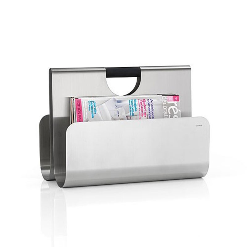 Magazine rack by Blomus in with a magazine and white background