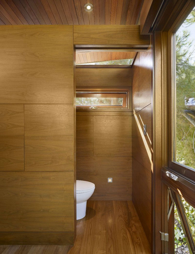 Bathroom with wooden floors and walls at The Banyan Treehouse by Rockefeller Partners Architects