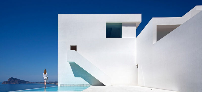 Swimming pool, white walls and stairway of the House on the Cliff by Fran Silvestre Arquitectos