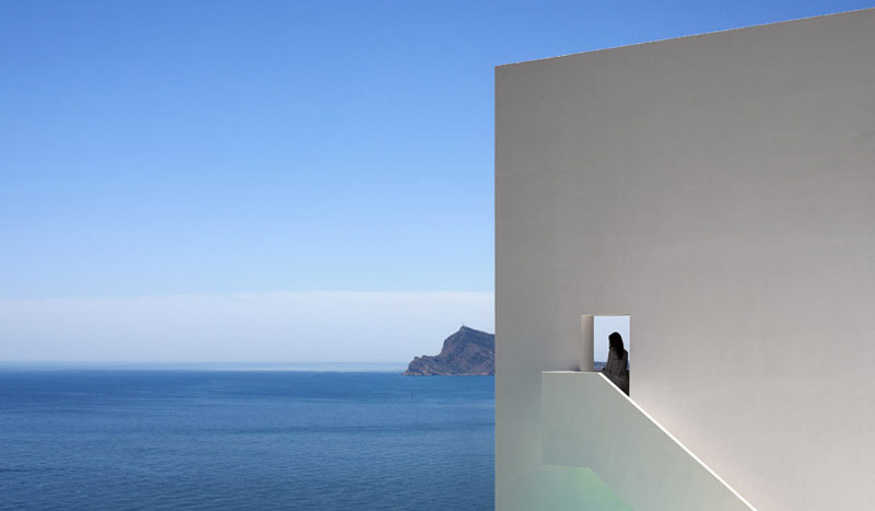 White wall and staircase overlooking the ocean at the House on the Cliff by Fran Silvestre Arquitectos