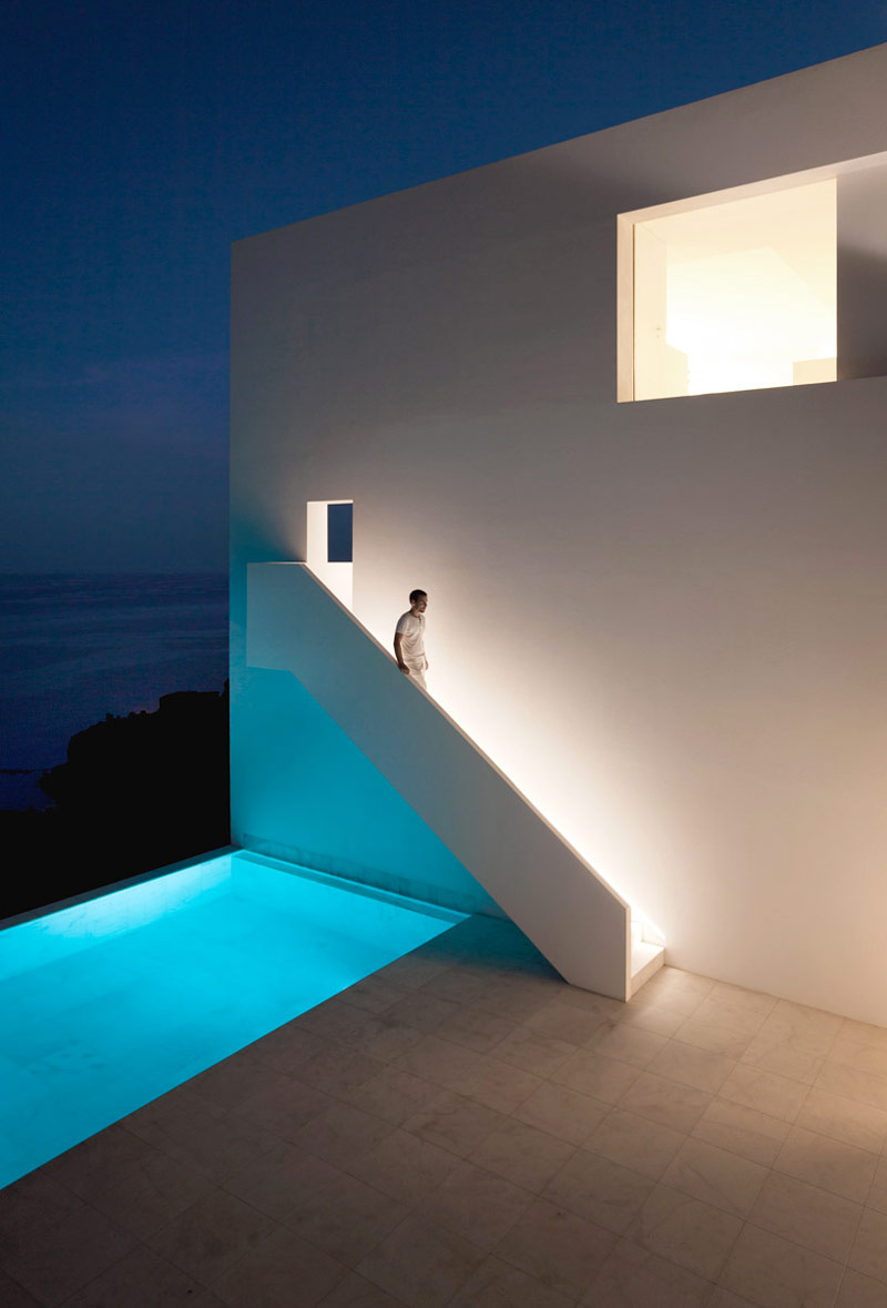 Swimming pool and white minimal stairway of the House on the Cliff by Fran Silvestre Arquitectos