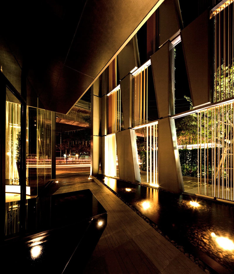 Interior design of a pond and windows at the Vertical Living Gallery by Sansiri and Shma in Bangkok