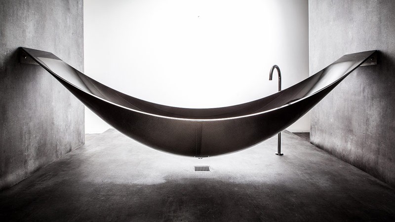 Side view of the Vessel Hammock Bathtub in a minimalistic bathroom by Splinter Works