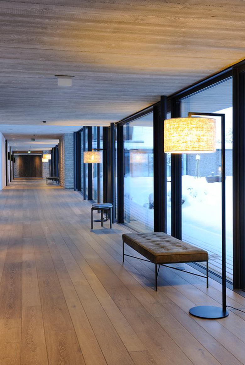 Floor to ceiling windows and benches at the Hotel Wiesergut in Hinterglemm Austria by Gogl Architekten