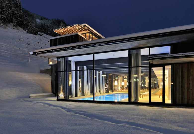 View of the swimming pool from the outside at the Hotel Wiesergut in Hinterglemm Austria by Gogl Architekten