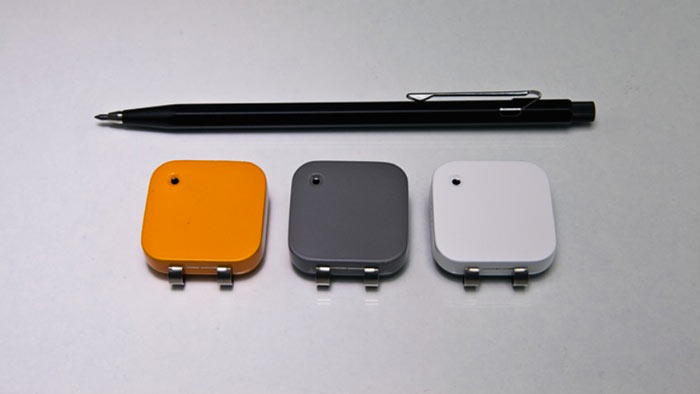 Orange, grey and white Memoto Wearable Camera and GPS