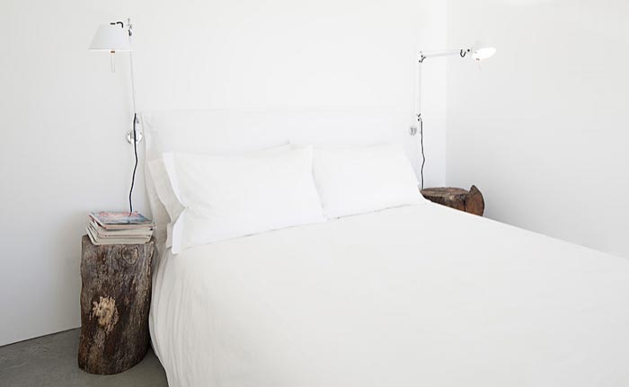 Bedroom with white walls and white sheets at the Casas na Areia in Comporta Portugal
