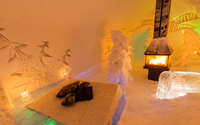 Interior design of a room with a fireplace at the Hotel de Glace, An Ice Hotel Quebec City, Canada