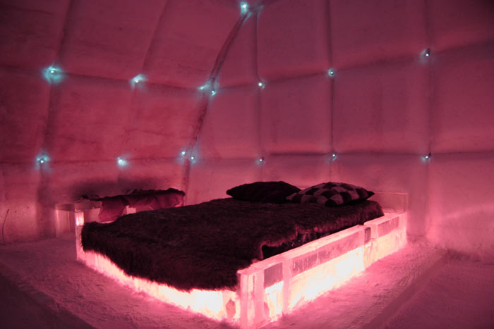 Bedroom with red lights at the Hotel de Glace, An Ice Hotel Quebec City, Canada