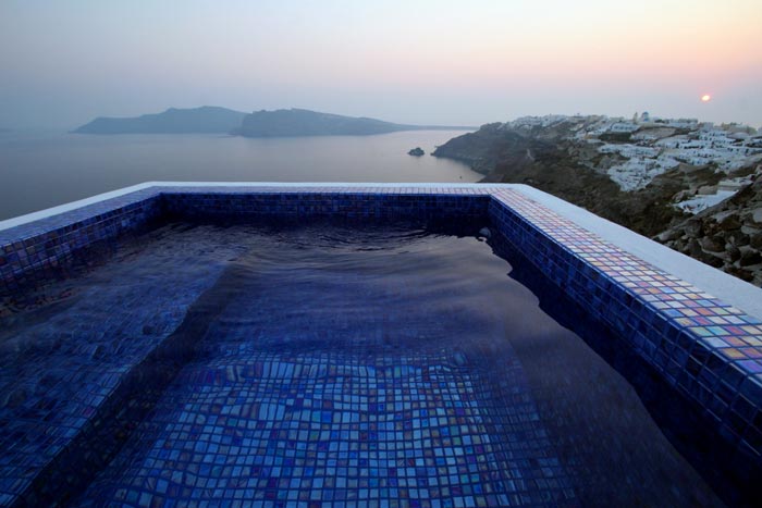 Outdoor pool with a beautiful view at the Ikies Traditional Houses in Santorini
