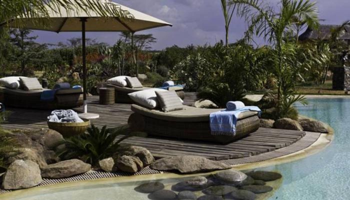 Lounge chairs near the pool at Segera Retreat in Kenya