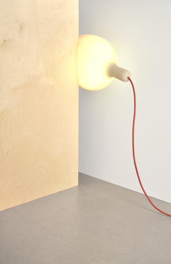Soft Light Lamp and Pillow by Simon Frambach placed between two walls