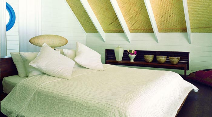 Bed in a bungalow at Cocoa Island Resort in The Maldives by COMO Group