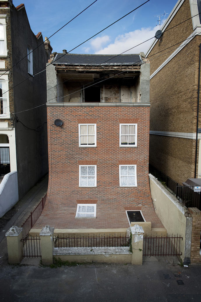 Facade of "From the Knees of My Nose to the Belly of My Toes" by Alex Chinneck