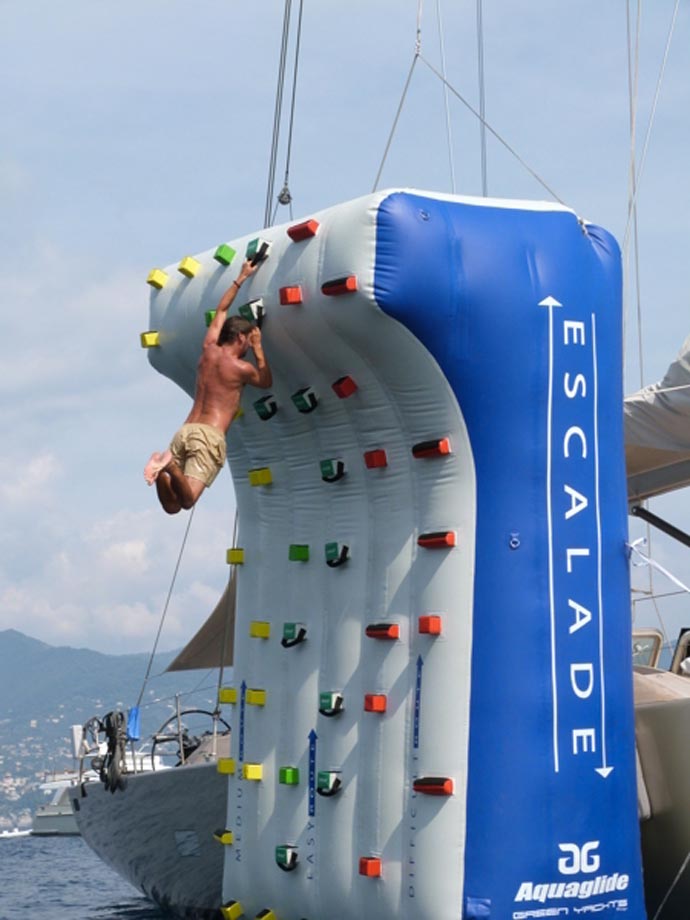 Man climbing an Inflatable Climbing Wall for Yachts by Green Yachts