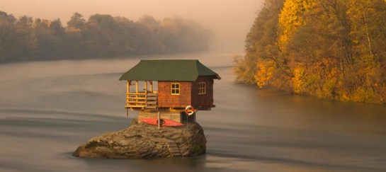 TINY WOODEN HOUSE ON DRINA RIVER IN SERBIA