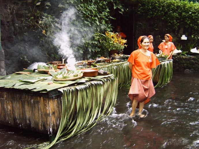 Women cooking at the Villa Escudero Resort Waterfall Restaurant in the Philippines