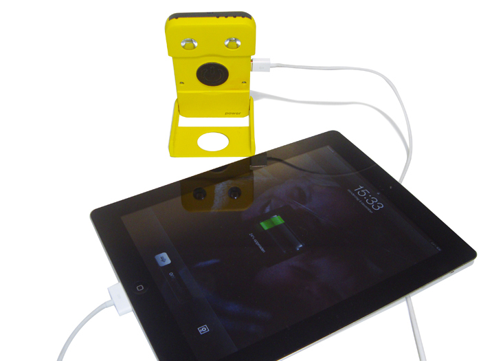 iPad being charged with the WakaWaka POWER Solar LED Lamp and Smartphone Charger