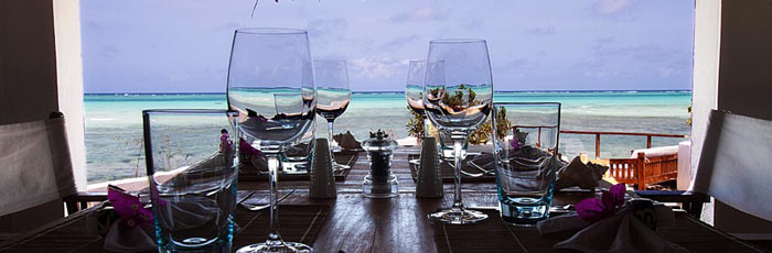 Wine glasses on a table overlooking the ocean