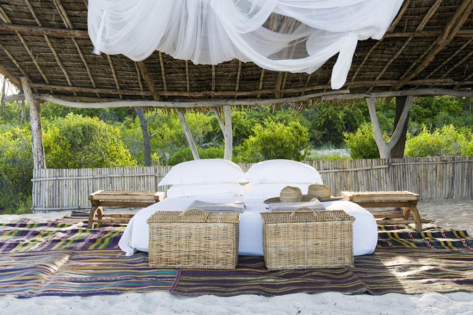 Outdoor bed at Vamizi Island Resort