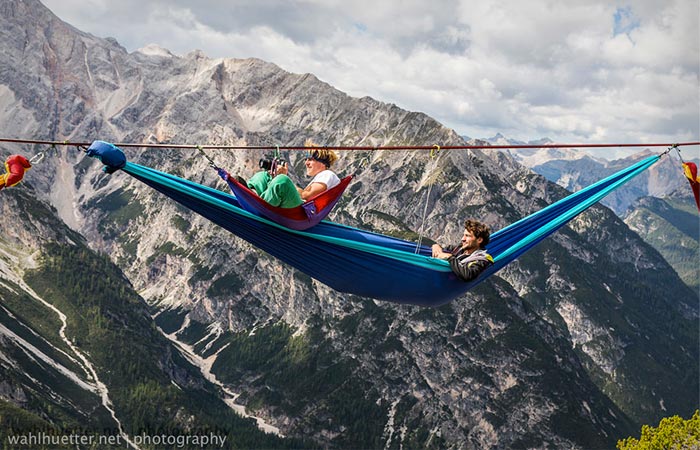 People in hammocks at the Slackline Festival in the Alps
