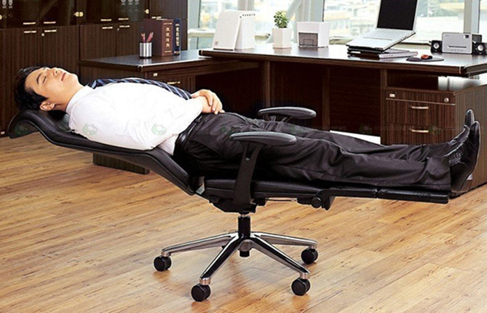 Man sleeping on Office Chair Bed