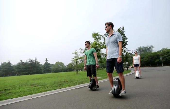 People using self balancing scooters on the street
