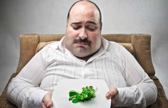 Sad man eating vegan food