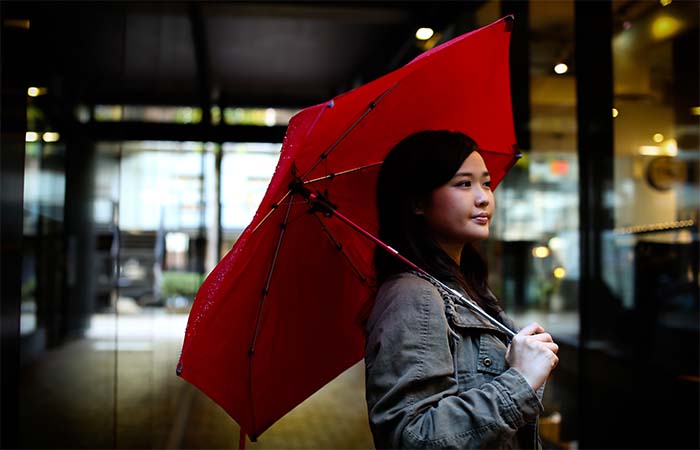 A girl holding red Cypress Umbrella 