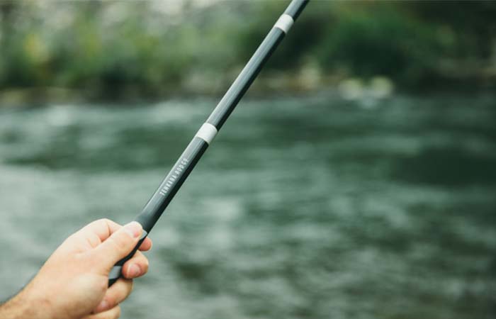Holding a Tenkara fishing rod over water